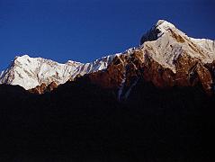 09 Nanga Parbat Rupal And East Faces, Rakhiot Peak From Tarashing At Sunrise The yellow light of sunrise quickly changes to white on the Nanga Parbat Rupal and East Faces from Tarashing. Rakhiot Peak is on the right. Gunther Messner�s diary May 15, 1970: The day dawns bright and cloudless. For the first time I see Nanga and Chongra Peak from the south: the impression is overwhelming. Huge hanging glaciers, terrifying precipices, furrowed by avalanches. Right over to the left is the summit of Nanga! (The Naked Mountain by Reinhold Messner)